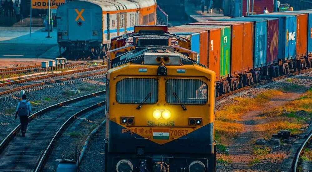 Cargo freight train operating on rail logistics infrastructure in India.