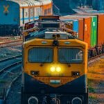 Cargo freight train operating on rail logistics infrastructure in India.