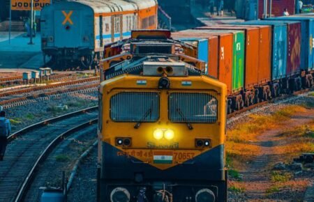 Cargo freight train operating on rail logistics infrastructure in India.