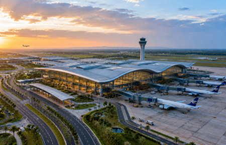A modern international airport terminal with aircraft, cargo facilities and transport links at Bhogapuram in Andhra Pradesh.