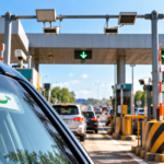 Car passing through a highway toll plaza using FASTag in India.